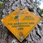 Sign on a tree for The Nature Conservancy