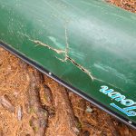 Cracked canoe in the woods