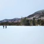 Volunteers standing on frozen Slaughter Pond