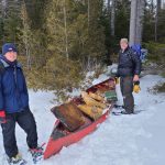 Chris Richmond and his son Carlton with an old canoe on snow