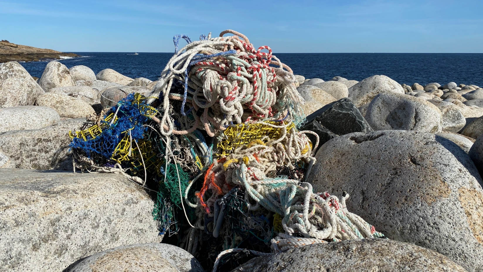 Pile of tangled rope debris on a rocky beach